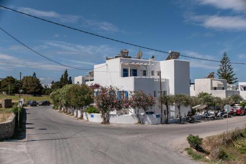 a white house on the side of a street at Livadia Seaside Studios 6 in Parikia