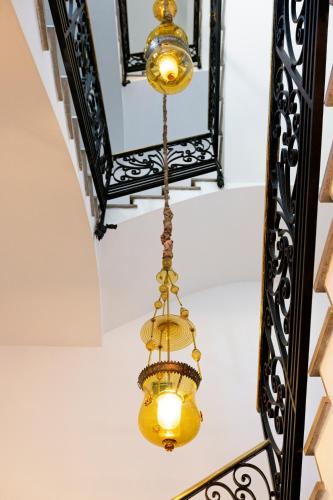 a chandelier hanging from the ceiling of a staircase at Hospes Maricel y Spa, Palma de Mallorca, a Member of Design Hotels in Cas Catala