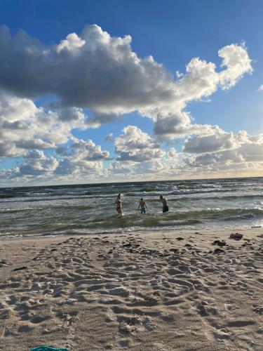 a group of people playing in the water at the beach at Katrina Summer House in Jūrmalciems