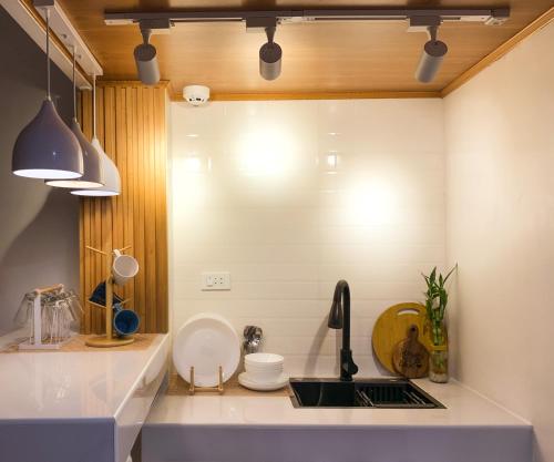a kitchen with a sink and a counter top at Ace Tiny Home in Alaminos - Home of the Hundred Islands in Alaminos
