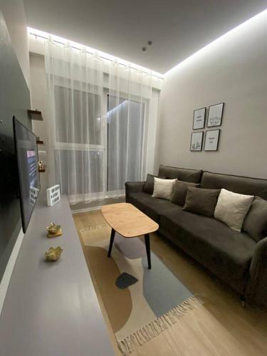- un salon avec un canapé et une table dans l'établissement Anika Home Tirana 1, à Tirana