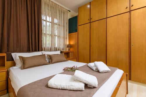 a bedroom with a large bed with two towels on it at Heaven's house in Kallirákhi