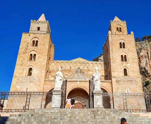 a large church with two towers and statues in front at L'angolo di Rosa in Campofelice di Roccella