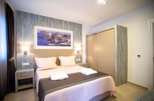 a bedroom with a bed with two towels on it at Queen Victoria Suit Apart OTEL in Bodrum City
