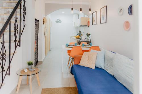 a living room with a blue couch and a table at Home Santa Clara in Albufeira