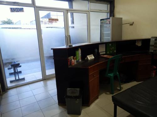 una oficina con un escritorio con un ordenador. en OYO 92591 Wisma Pangestu Syariah en Ujungtanjung
