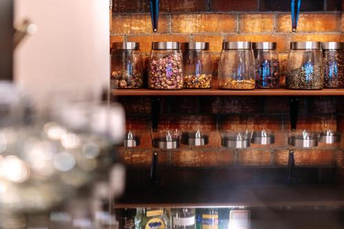 a shelf with jars of sprinkles on it at Hotel Ambiente Wellness & Spa in Karlovy Vary