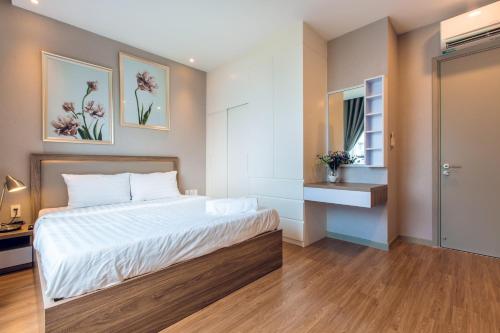 a small bedroom with a bed and a window at Luxury Gold Apartment 86 -Rooftop Pool Central City in Ho Chi Minh City