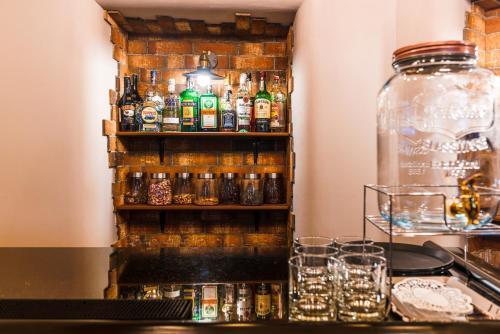 a bar with a bunch of bottles and glasses at Hotel Ambiente Wellness & Spa in Karlovy Vary