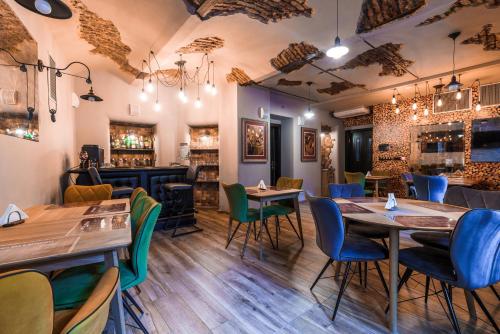 a restaurant with tables and chairs and a bar at Hotel Ambiente Wellness & Spa in Karlovy Vary