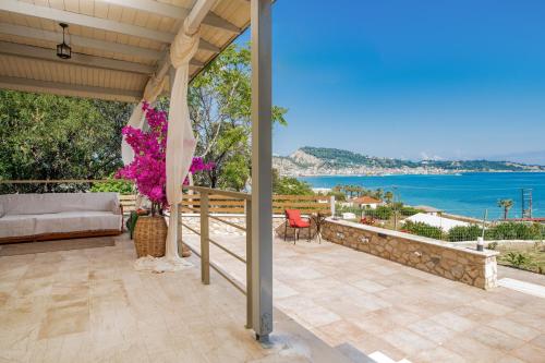 an outdoor patio with a view of the ocean at Orientem Villa in Argasi