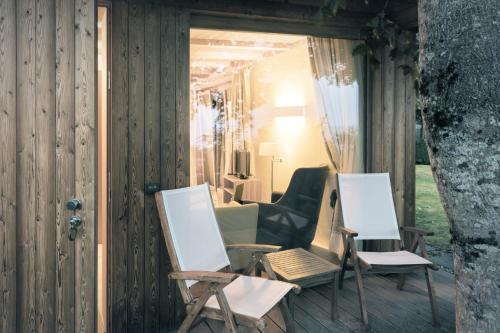 two chairs and a table on a porch at Parkhotel Holzner in Soprabolzano