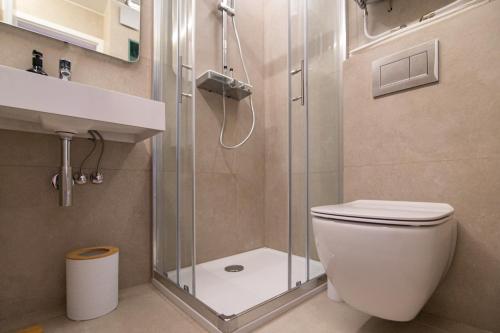 a bathroom with a shower and a toilet and a sink at MIZU APARTMA VAS LIPA OLIMJE in Podčetrtek