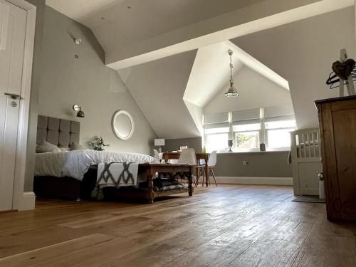 a bedroom with a bed and a table in it at LymingtonBnB in Lymington