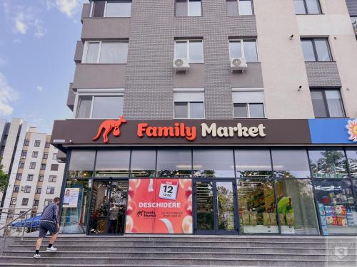 a man walking in front of a store at RentHouse Apartments Premium Living in Chişinău