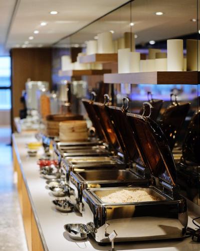 a buffet line with many pots and pans at GOGO Hotel 市政館 in Taichung