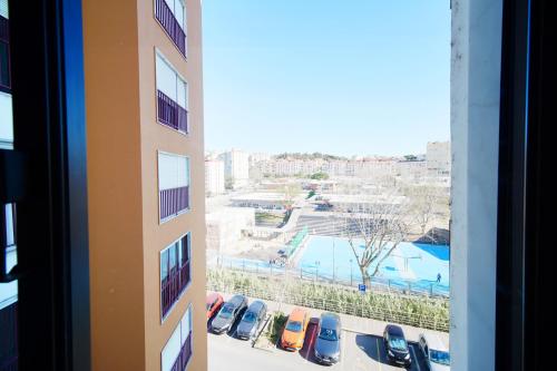 a view from a window of a parking lot at Amazing Apartments in Agualva