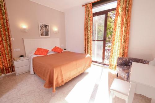 a bedroom with a bed and a large window at Hostal Ramos in Barcelona