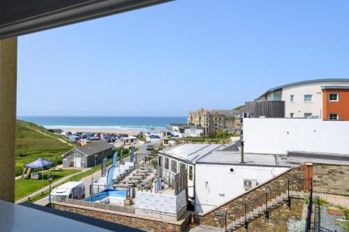 a view of the ocean from the balcony of a building at Beachcombers Apartments in Newquay