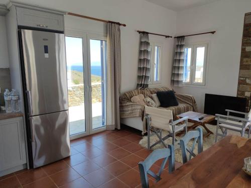 a living room with a couch and a table at Lighthouse View Syros in Azolimnos Syros