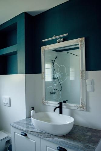 a bathroom with a white sink and a mirror at Villa Aqua in Mostar