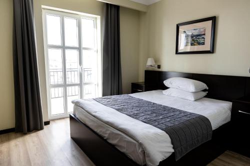 Ένα ή περισσότερα κρεβάτια σε δωμάτιο στο Chagala Aktau Hotel
