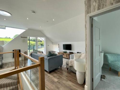 a living room with a couch and a table at 1 The Boatyard - Water fronted, town location & parking for 2 cars in Kingsbridge