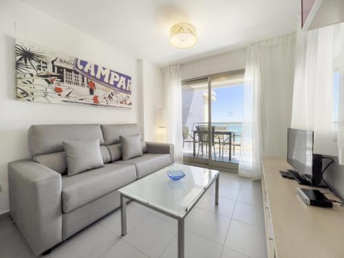 een woonkamer met een bank en een tafel bij Apartamentos Hipocampos Calpe Rent Apart in Calpe