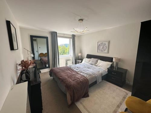 a bedroom with a bed and a large window at Chic 3 Bed in the heart of Chiswick in London