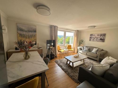 a living room with a couch and a table at Chic 3 Bed in the heart of Chiswick in London