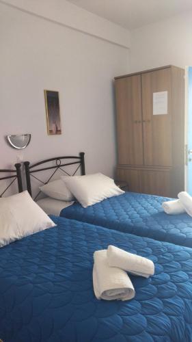 a bedroom with two beds with towels on them at Elzahed apartments bonaccia in Kimolos
