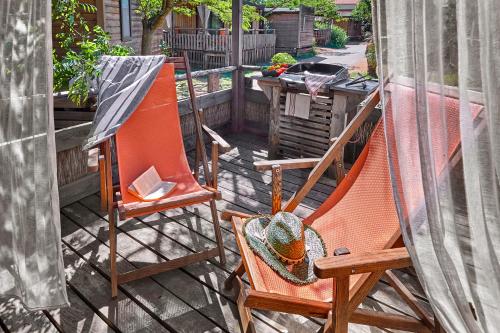 two chairs sitting on a patio with a table at Au Paradis des Campeurs in Les Issambres