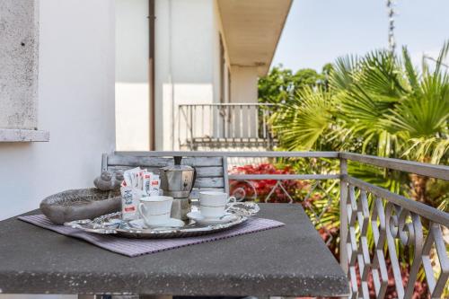 a tray of tea cups and coffee on a table on a balcony at Cà Fernanda in Fiesso Umbertiano