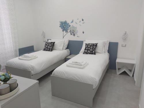 ラ・スペツィアにあるCandy's dream roomsのベッド2台とソファのある小さな部屋