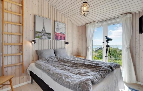 a bedroom with a bed with a view of the eiffel tower at Amazing Home In Faaborg With Wifi And 3 Bedrooms in Fåborg