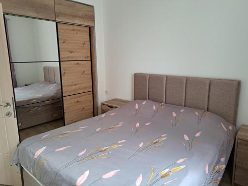 a bedroom with a bed and a dresser and a mirror at Magical View in Budva