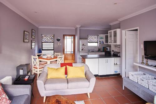a living room with a couch and a kitchen at 2 The Mews - easy walk to town and the CVC in Clarens