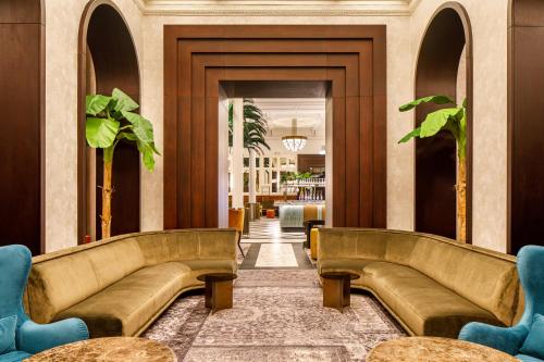 a hallway with couches in a lobby at The Municipal Hotel Liverpool - MGallery in Liverpool