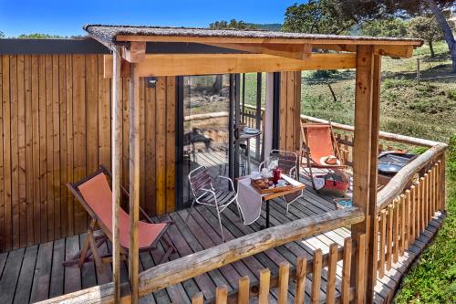 a wooden deck with a gazebo at Au Paradis des Campeurs in Les Issambres