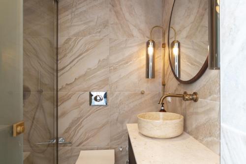 a bathroom with a sink and a shower at Naiades Boutique Hotel - Adults Only in Elounda