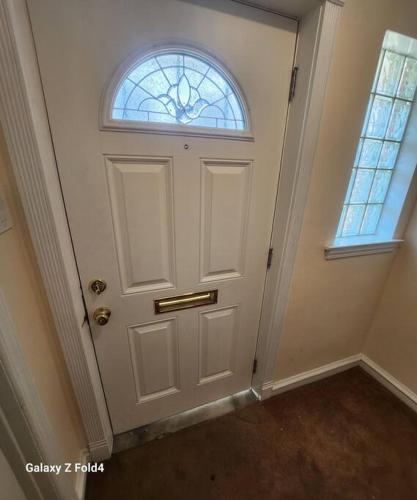 a white door with a window in a room at Cozy 1 Bedroom Business Suite in Philadelphia