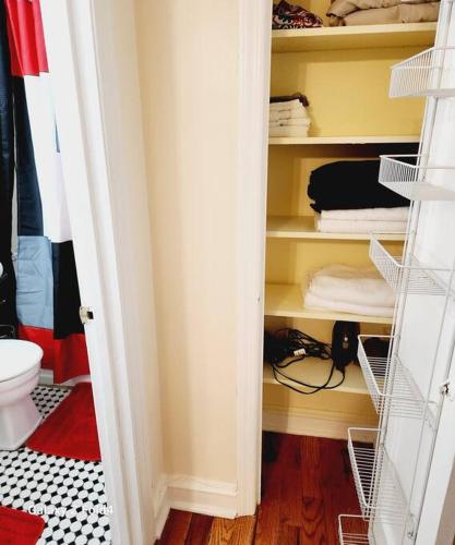 a room with a closet with a toilet and towels at Cozy 1 Bedroom Business Suite in Philadelphia