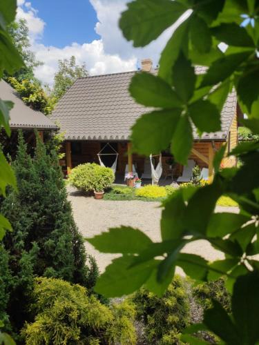 a house with a garden in the background at Chmielna Chatka in Majdan Łuczycki