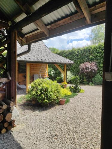 a wooden pavilion with a gazebo in a garden at Chmielna Chatka in Majdan Łuczycki