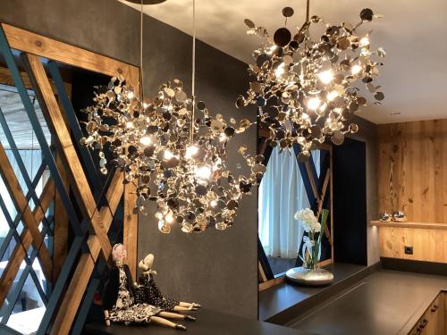 a chandelier in a kitchen with a table at Hotel Costes in Corvara in Badia