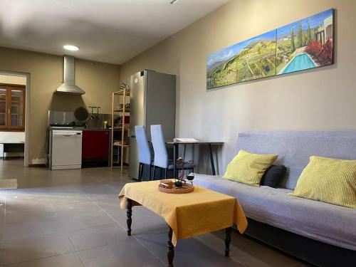 a living room with a blue couch and a table at Casa rural con vistas maravillosas en Arico in Sabina Alta