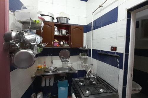 a small kitchen with a sink and a stove at Real Egypt is waiting for you in Sinnūris