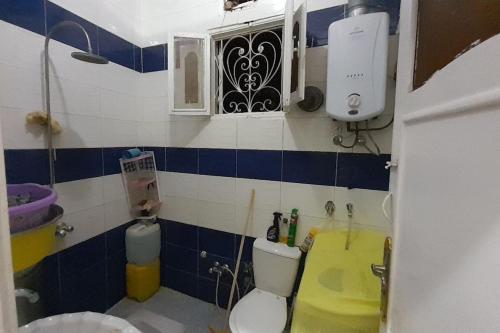 a small bathroom with a toilet and a sink at Real Egypt is waiting for you in Sinnūris