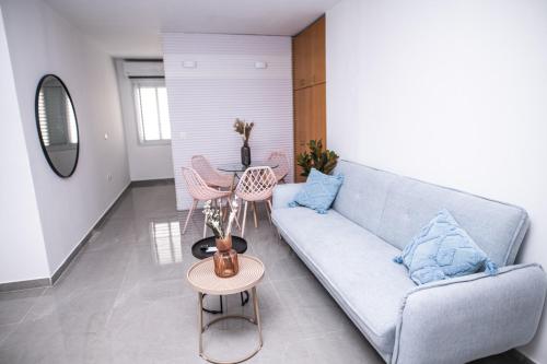 a living room with a couch and a table at King's rooftop in Tel Aviv