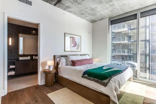 a bedroom with a large bed and a large window at 2 BR Lux Panoramic View - Rainey in Austin